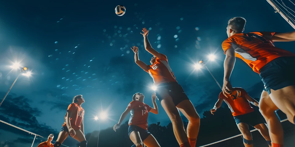 volleyball-players-leaping-ball-stadium-lights
